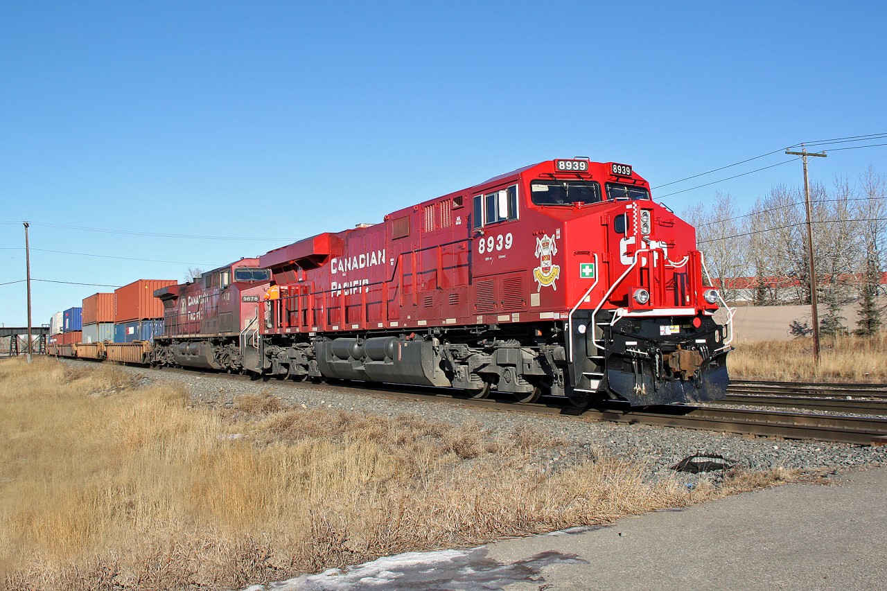 ES44AC CP 8939 carrying a crest honoring the Lord Strathcona's Horse Royal Canadian Armoured Regiment of the Canadian Forces heads east away from CP Alyth Yard in Calgary.  The second loco is AC4400CW CP 9678.