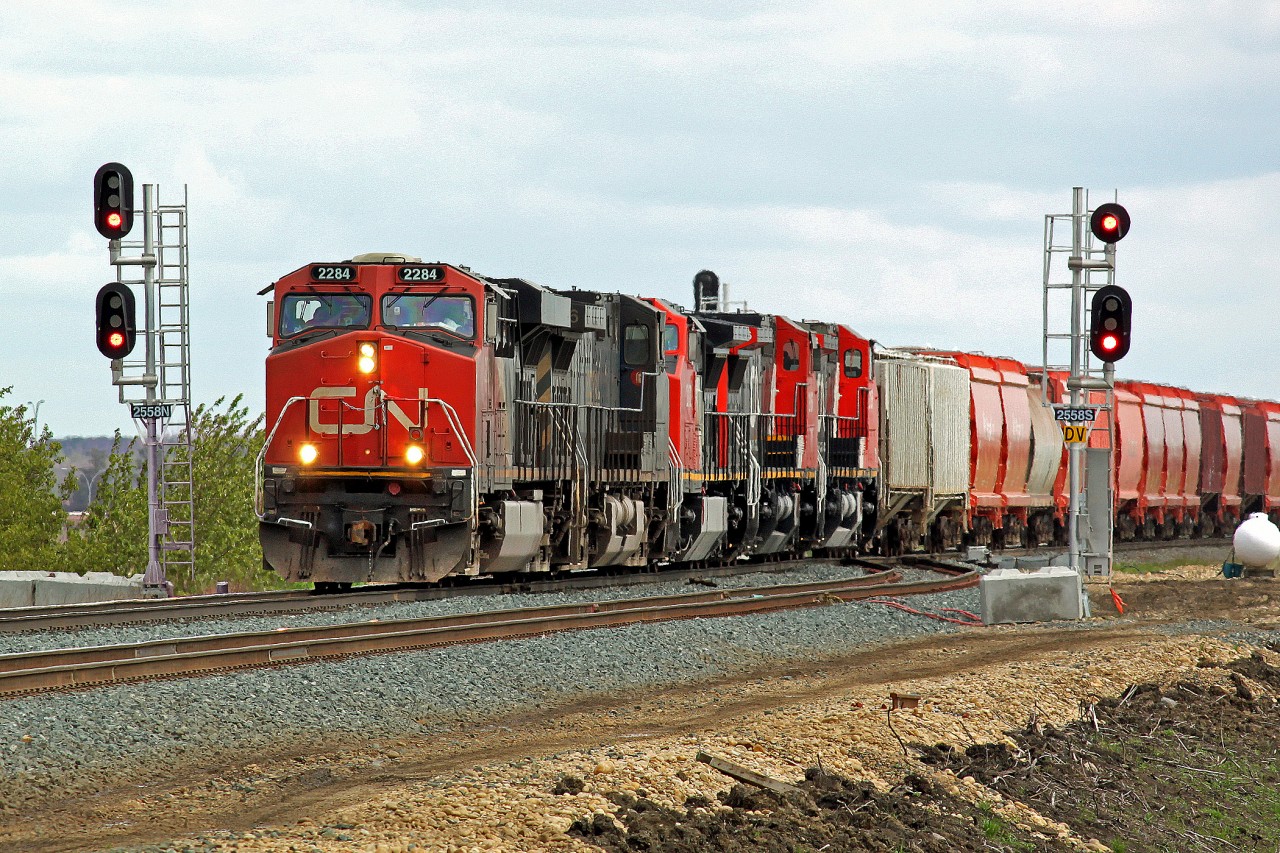 Heading west onto the new double track section at Clover Bar are ES44DC CN 2284, Dash9-44CW CN(ex BCOL)4644,DASH8-40CW CN 2166 (ex BNSF 804) and CN 2158 (ex BNSF 846)