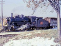 Canadian National "Ten Wheeler" 1322 pauses at Meaford before returning to Collingwood, on CN's Meaford Subdivision in 1958.<br><br>1322, an H6c class Mikado, was built in 1910 for the Canadian Northern Railway. It was donated to the City of Barrie in 1960 (after being renumbered 1531) and survives today owned by the Simcoe County Museum in Midhurst, ON.<br><br><i>[Editor's notes: Operations on CN's Meaford Sub, which originally ran 52 miles to Meaford from Barrie, were transferred when Barrie and Collingwood both stepped in to buy portions of the line in 1996 when CN wanted to abandon it. It is now part of the <a href=http://www.railpictures.ca/?attachment_id=6943><b>Barrie Collingwood Railway</b></a>, with operations contracted to Cando. However, in 2011 Collingwood decided to discontinue rail service over their portion of the line from the CPR interchange at Utopia to Collingwood. The Barrie section of the former Meaford Sub remains active].<br><br>Note, geotagged location not exact.<i>