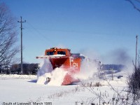 I was working in the Listowell area in March of 1985 and heard on my scanner that there was a plow extra heading south on the CN Newton Sub (later west) to Kincardine. I had time to go to a side road south of town and set up near a crossing and the plow soon appeared. I took my photo just before it passed then WAM, I was bowled over by a sheet of heavy snow and knocked over a fence (I was not injured but it was a shock). I then went to a local restaurant and tidied up my clothing. The resulting photo was average but it brings back memories: CN snowplow 55408 charging across a grade crossing south of Listowel, propelled by a pair of GP9 units.
<br><br>
<i>[Editor's note: CN plow 55408, a wedge plow built by Eastern Car Co (Trenton NS) in 1937, mets its end not too long ago after avoiding the scrapper once. Once it was retired from CN in the 90's (many lines being abandoned or torn up in the southern Ontario area reduced the need for plows) it was sold to Zubicks in London for scrap. In 1995 the Goderich Exeter Railway traded their plow, 55437, to Zubicks for 55408, as it was in better shape. Known by some as their "orange plow" (they also owned sister 55413 painted black), it continued the fight on mother nature for its new owner until recently, when it was cut up for scrap in Goderich during May 2013.]</i>
<br><br>
<i>(Note, geotagged location may not be exact)</i>