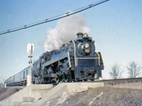 CN Toronto to London passenger train 75 with Hudson 5702 crosses Cooksville Creek at Mile 11.8, on the Oakville Sub in 1957. While competitor Canadian Pacific had a healthy fleet of 4-6-4 Hudson steamers, Canadian National only had 5: CN 5700-5704, K5a class units built by MLW in 1930. 5702 and her sisters were used in passenger service out of Toronto's Spadina Roundhouse until the end of steam, and today 5702 can be found on display at the Canadian Railway Museum (Exporail) in St. Constant, QC. Sister 5703 (as 5700) is at the Elgin County Ry Museum in St. Thomas ON.