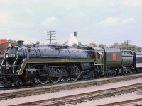 During a steam excursion on September 21st 1975, CN's "Bullet Nose" 4-8-2 Mountain 6060 is seen here in Guelph ON uncoupled from her train. Part of a 20 locomotive order from MLW in 1944 (U1f class), the 6060 currently resides out west at the Rocky Mountain Rail Society in Alberta, in operating condition.<br><br>