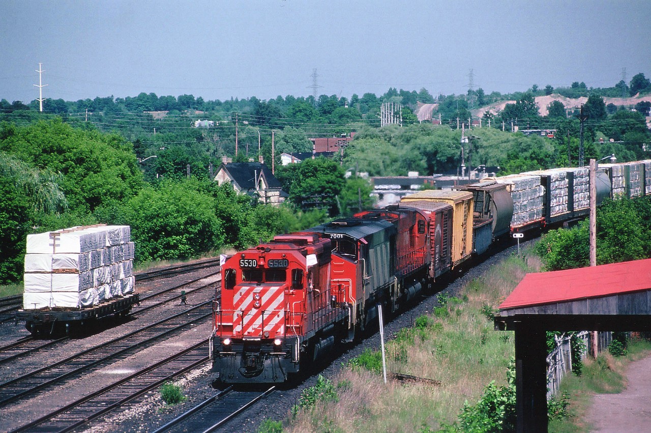 Westbound approaching mile 57 Galt sub., CP 5530, CN 7001 and CP 4705 seen as #937 from up on the Hwy 8 overpass. The middle unit is the x-CN 2100, reacquired by Bombardier along with 2101-2103 to operate as demonstrators 7001-7004 on CP between Feb 1983 and May 1984. The BBD HR616 3000 HP units were rated 3200 HP while on CP. After the trial, the units reverted to their old slotting on the CN roster. CP did not take an interest, and just as well, this model was associated with aggravations and the CN fleet was off roster by 1998.
