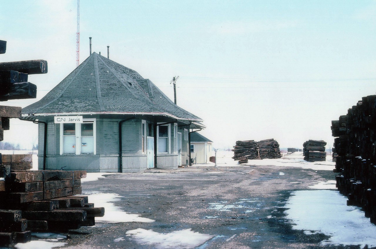 The old CN Jarvis station on the former CN Cayuga line, recently deceased . Rather than post a shot of this structure with track in place, I felt this one had more significance to it. There must have been an unsettling feeling being surrounded by the remnants of what once was. There were stacks of ties as far as one could see; the distant background is where the current SOR line to Nanticoke crossed. Today, the station still stands, alone, nary a tree nearby, once again failed business tried to keep the station in usefulness.......a For Sale sign currently adorns the building. At least it was saved.