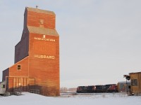 The classic wooden grain elevator! CN 2596 west takes the siding at Hubbard as it makes it way past the abandoned grain elevator.