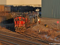 In the dying light of a perfectly sunny and cold winters day, CN 4112 and 7029 pull four loads from the Gerdau Ameristeel plant in Whitby, Ontario. Arriving light from the yard in Oshawa and after a brief fight with the switch into the plant trackage off the South Service track, they darted into the plant yard, grabbed their lift, and retreated back to Oshawa. 1856hrs.
<br><br>
Wonder when this type of scene will be a thing of the past? With 50 plus years under their belts, he GP9 has surely outlived the iron horses that they replaced in the 1950's... a remarkable feat given the mileage they've racked up before and after remanufacture, and the fleets that have come and gone while they've kept toiling away with little fanfare.
<br><br>
CN 4112 started life as CN 4249 in 1958, so she isn't one of the oldest on the roster, however having been remanufactured into a GP9RM in 1984, she has actually toiled in this form longer than in her original high hooded configuration.
<br><br>
The trailing unit, CN 7029, was built as CN 4150 in 1959, renumbered to 4391 in 1984 to make room for the 4100 series GP9RM's (which never went above 4143). CN 4391 Finally went into PSC for conversion to a yard goat in 1991.