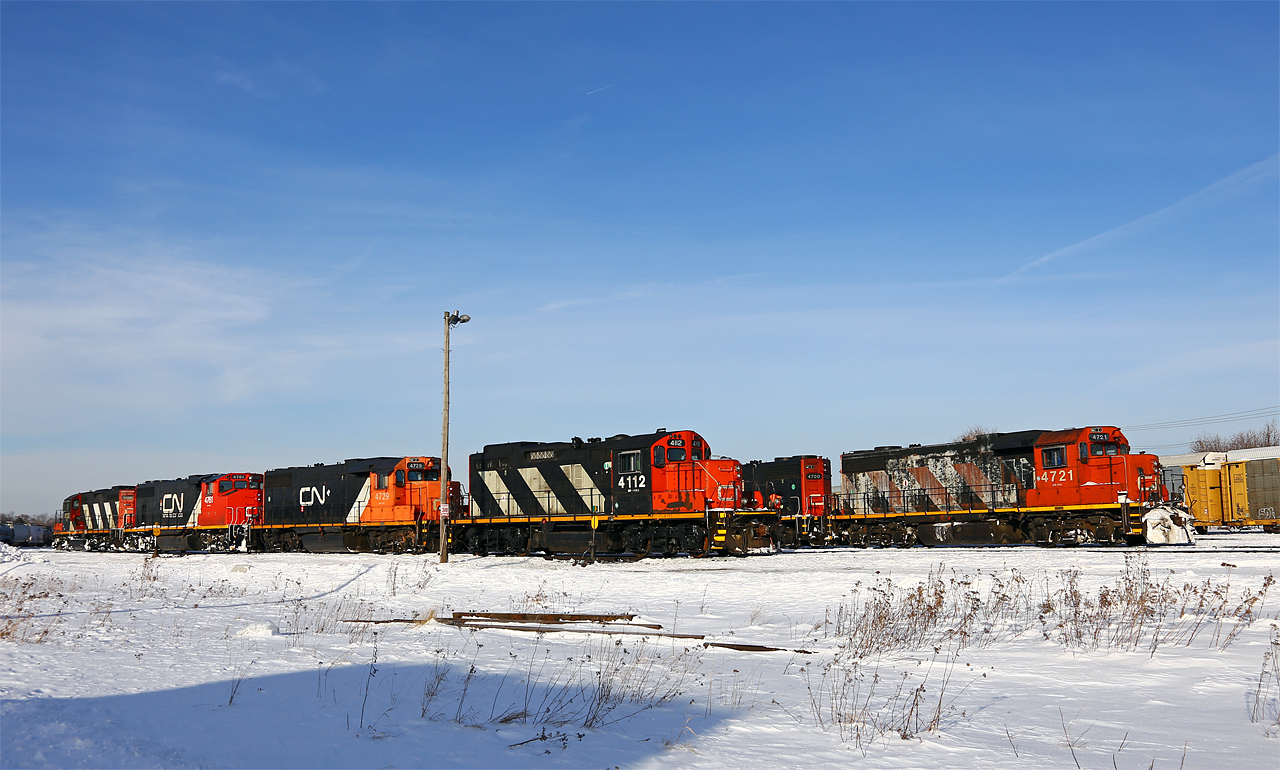 As Tim Allen would say, "more power!". On this very cold morning, the Racecourse job is switching with all four London-assigned units (CN 4112, 4729, 4761, 4130). On the 12 track lead in the background is CN 438 (4721-4700) who have just separated their train into two tracks (Sarnia and Toronto cars) and are heading to the west end of the yard to wait until their train is built. The next morning, these two engines would be involved in a minor fender-bender at the west end of the yard and later sent to Toronto for repairs.
