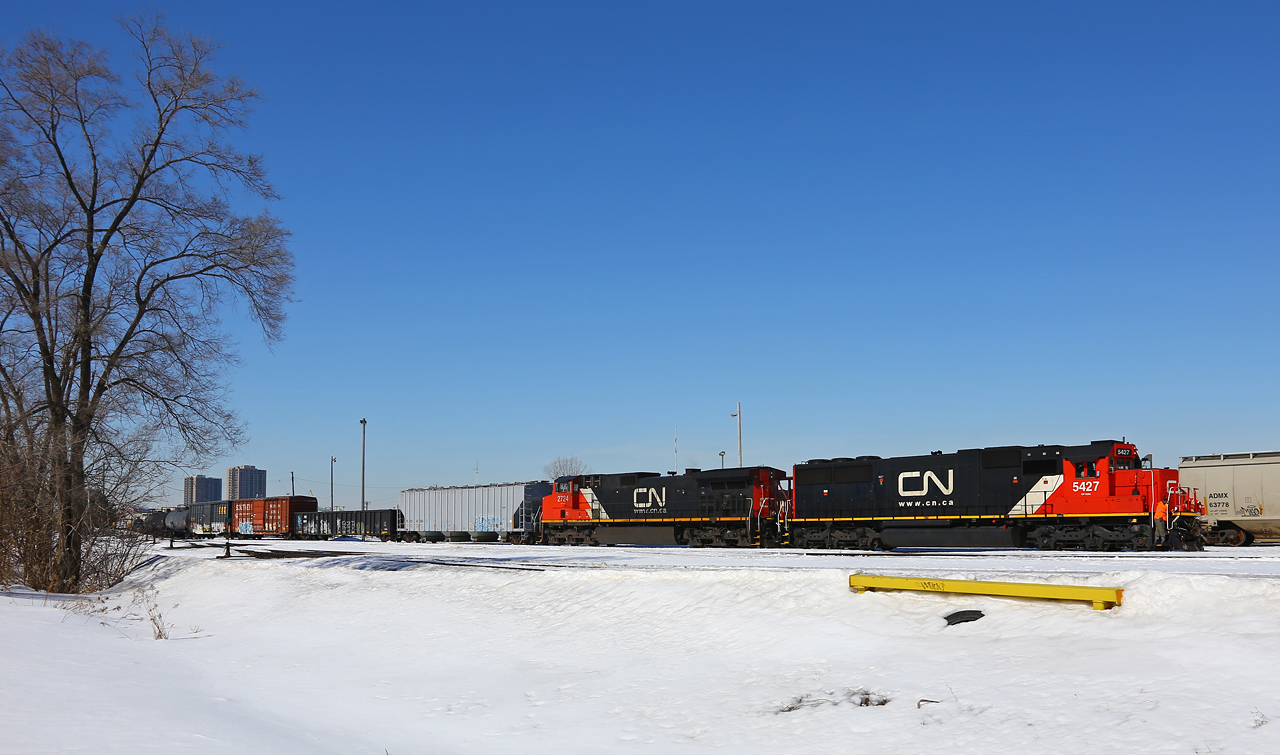 The CN Racecourse crew has relieved the inbound 509 crew as they pull the relatively short train into track 18 at the west end of the yard on a spectacular March day.