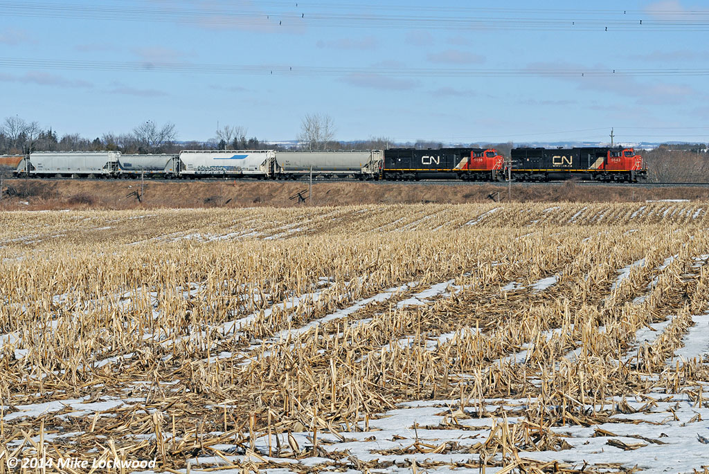 CN 5643 and 5656 roll 372's train east at Newcastle, Ontario. 1054hrs.
