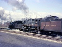 <b>Steam Doubleheader!</b> CPR G1-class Pacific 2232 assists H1b-class standard Hudson 2815 as they pass by West Toronto Station in a cloud of smoke, about to cross over the diamond(s) at West Toronto junction and head north on the Mactier Sub. Note the West Toronto interlocking tower, demolished sometime in the mid-late 60's when the interlocking plant was modernized. The train is about to take the connecting track leading from the east track of the Galt Sub, across the double main tracks of the North Toronto Sub, and onto to the MacTier Sub (the ex-Toronto Grey and Bruce line) just to the north. Often used by The Canadian in later years, it's since been removed. West Toronto Station was demolished by the CPR in 1982, despite efforts by groups and the city to save it.