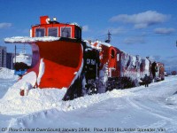 30 years ago when I was in Owen Sound and it had snowed the day before, I asked the CP operator if a plow train had been called for. He said one was working up from Orangeville. I spent some time looking for him but was only able to get a few distant shots along the line just as he was heading down the escarpment. Also one shot of a freight that was right behind him.  <br><br> Shown here is the aftermath of the trip: CP plow 400778 (the regular assigned Orangeville/Owen Sound Sub plow) along with RS18's 8766 and 1814 caked with snow, a Jordan spreader, and van on the rear, all sitting at the station in Owen Sound.