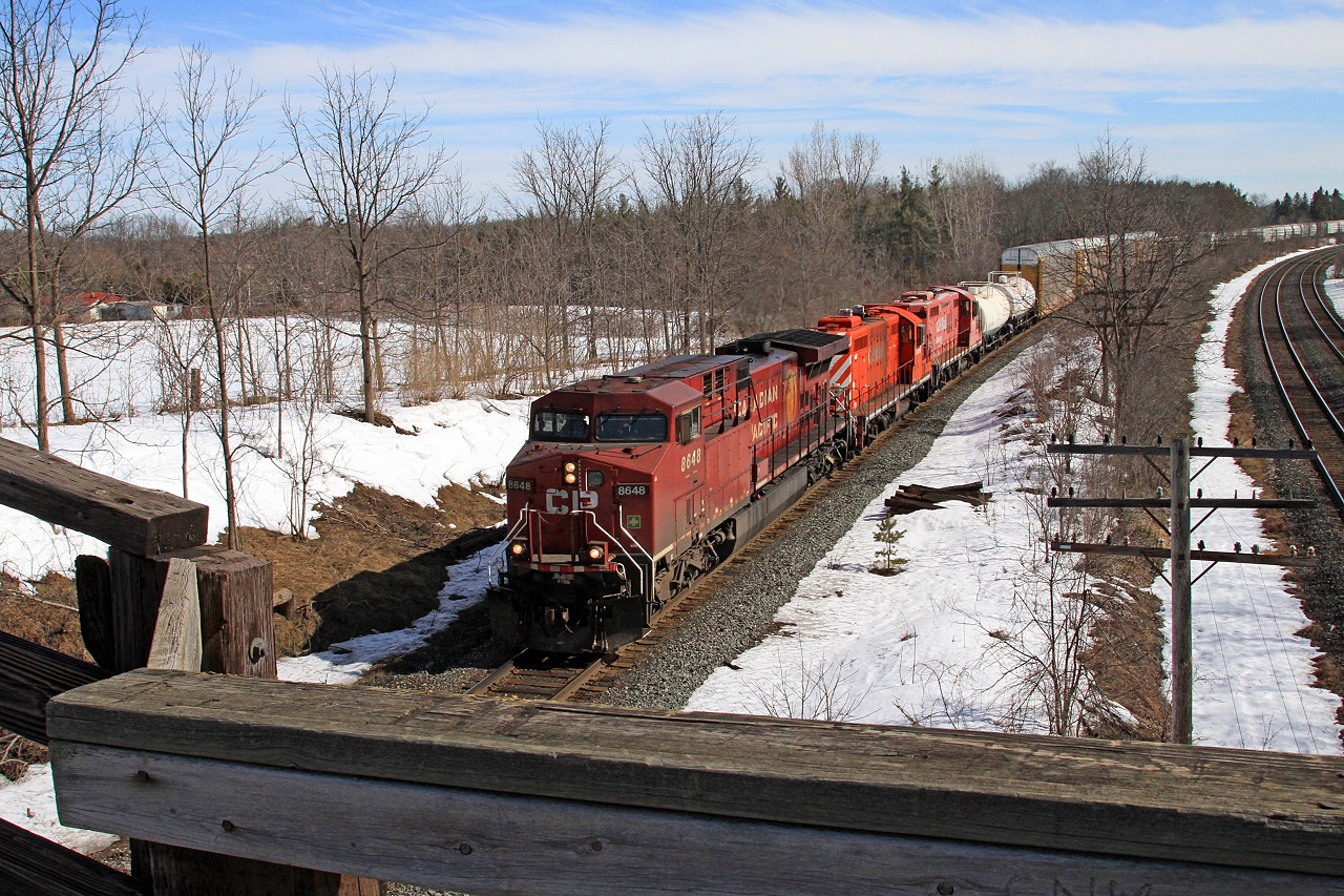 From the Denfield Road bridge CP 8648, with trailing clunkers CP 1690 and 1549, is westward with train 241-20 at mile 5.5 on the CP's Windsor Sub.