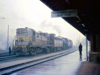 CP RS18 8744 and an FA1 help Mikado 5147 at Galt Station, on a rainy day in October 1959. The MLW-built 8744 was only two years old at the time, but the 5147, a P1-class 2-8-2 unit built in 1913 (also by MLW) was nearing the age of 47 and didn't have much longer - steam operations were quickly winding down in the late 1950's on Canadian Pacific.