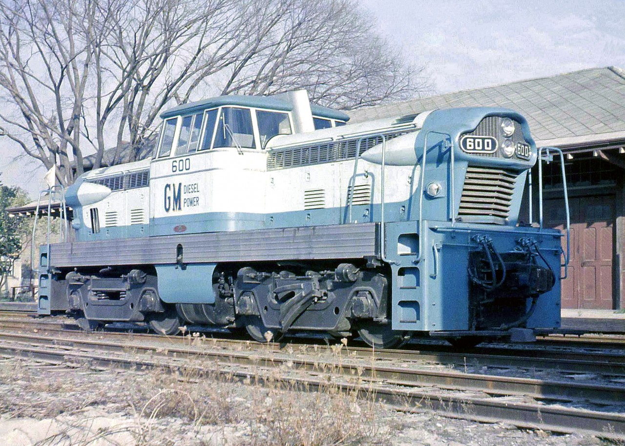 General Motors diesel-hydraulic switcher 600, a "GMDH-1", is seen here on trial on the Canadian Pacific Railway at St. Marys, Ontario in 1958. An experimental locomotive concept that never caught on, a total of four demonstrator GMDH-1 locomotives were built at GMD's London ON plant in the mid to late 50's, equipped with two large truck-sized diesel engines mated to a pair of hydraulic transmissions. GM's automotive department no doubt had a hand in the carbody styling. No orders were to follow from CNR, CPR or other railways, which were by then well into dieselizing their fleets (with the more popular diesel-electric locomotives).  Number 600 was the second unit built (serial number A1713, blt September 1958). Reports indicate it was later sold to a railway in Brazil and is now scrapped. The other three fared a little better:  while one was sold to a contractor and sent to Pakistan, the original demo 1001 resides at the Canadian Museum of Science & Technology (it had been the GMD London plant switcher for years). Another unit, after changing hands more than half a dozen times, remains active to this day at a petroleum company in Kaybob, Alberta. A single GMDH-3 was produced, essentially a smaller version (with only 3-axles and a single engine/hood), that now resides at a preservation society in southern Michigan.  Geotagged location may not be exact.