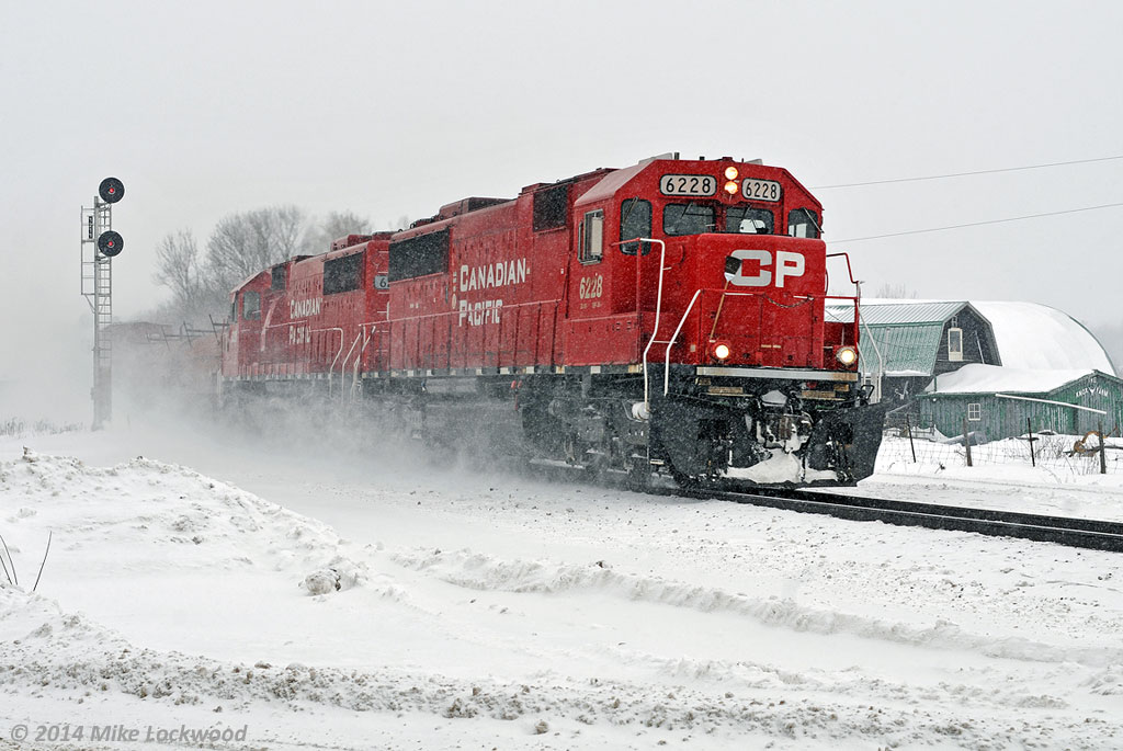Running short on time, the crew has the whip to CP 6228 and 6251 as they hammer by the west switch of Colborne siding. Ahead lines one meet (241 at Roblindale with CP 8548 and SOO 6027), where 142 will grudgingly take the siding, then a straight shot all the way to Smiths Falls. 1329hrs.