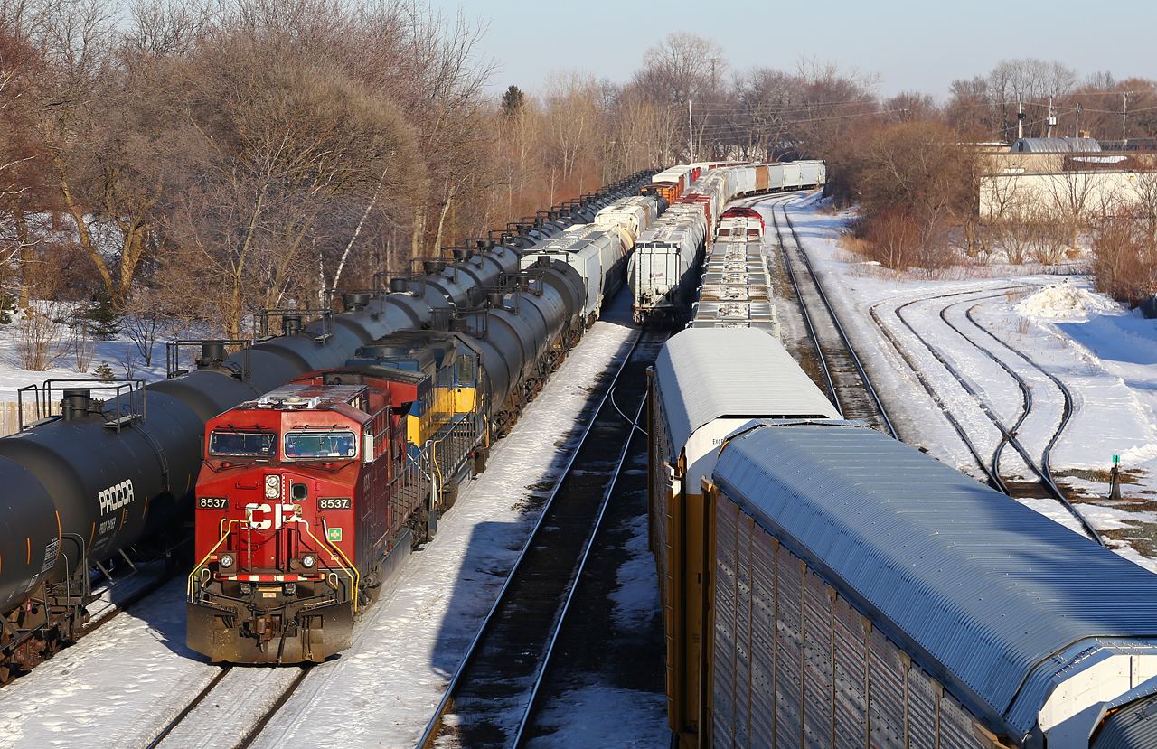With 608 on the main, the yard job switching on the lead and #2 track, and cars on #1 track, CP 8537 and ICE 6430 pull 241 down the only clear track at the east end of the yard (passing track).