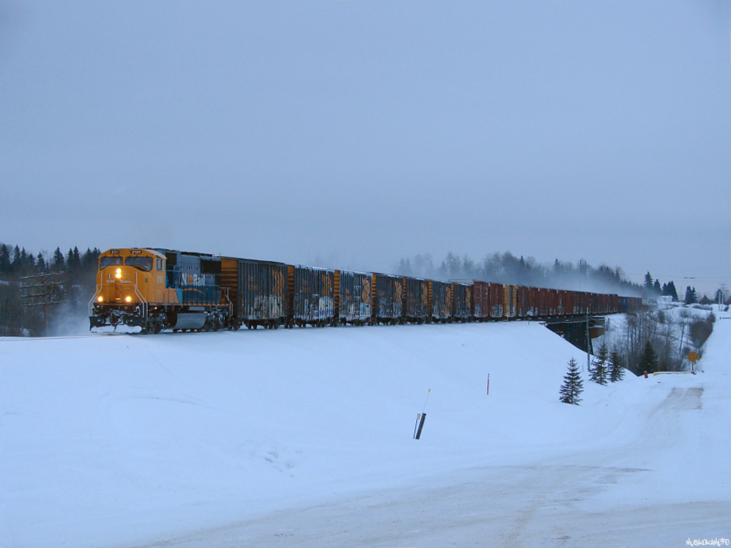 ONT 2101 North working on 213's daily freight from Englehart to Cochrane, with work at Iroquois Falls, highballs past the prison located beside ONR's Ramore sub 79.3 miles from Englehart, just off of Highway 11!