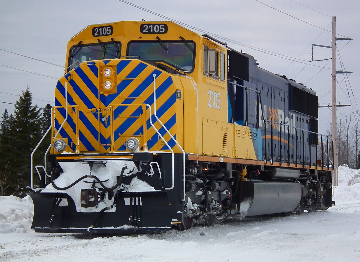SD75I 2105 complete with her new 'safety stripes' rolls off the wye at Cochrane March 3rd.