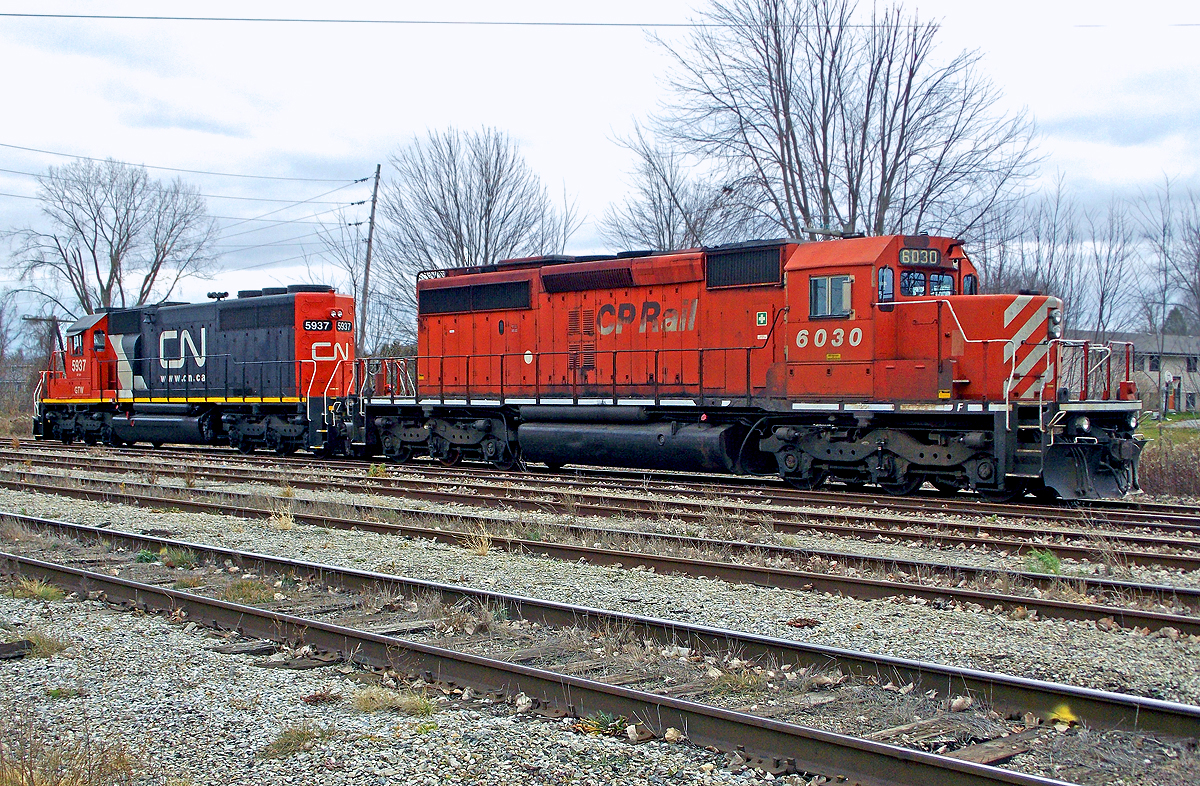 End of the line for the Canada Southern Railway. CP SD40-2 #6030 & GTW SD40-2 #5937, power for the CASO rail removal train, sit at the yard in Chatham, ON. Most of the ex-New York Central subsidiary's line from Fort Erie to Windsor is now just a memory. For more pics & videos from my collection see my website at  http://northamericabyrail.info  (New trips added)