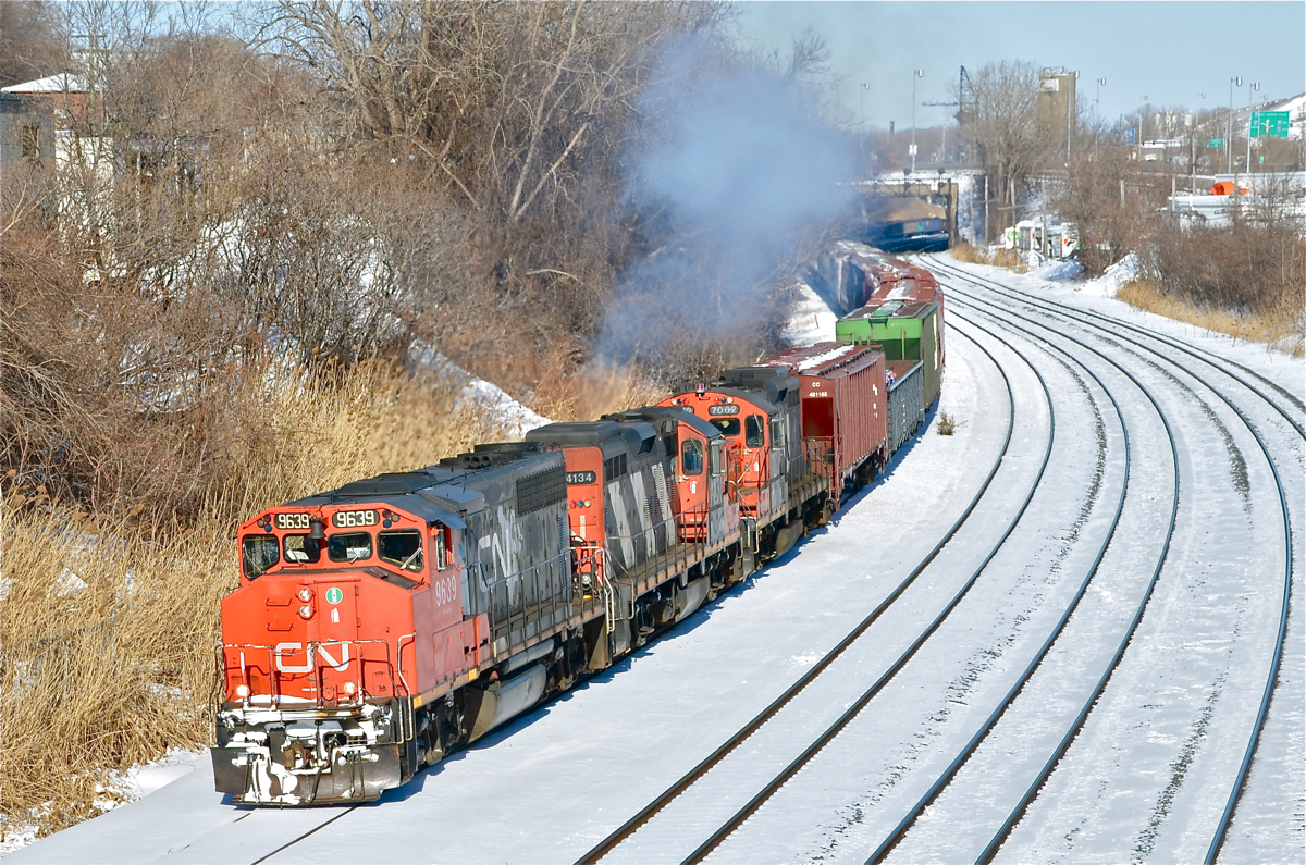 CN 527 with CN 9639, CN 4134 & CN 7062 head west through Montreal West on the transfer track. For more train photos, click here.