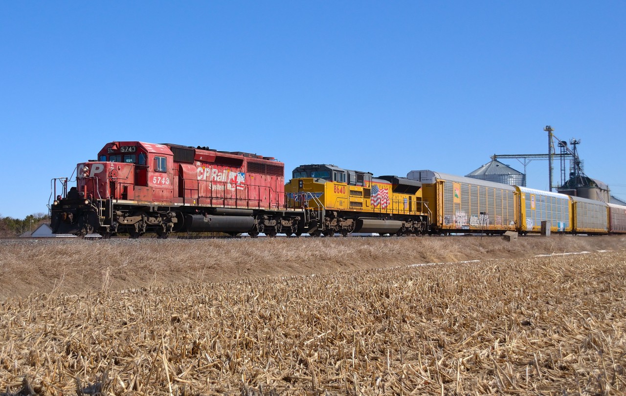 CP 235 passes by the grain elevator at Haycroft on its way towards Walkerville led by CP 5743 & UP 8640