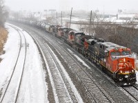 <i><b>21,800 horsepower.</b></i> With a snowstorm just beginning, a later than usual CN 305 heads west after a crew change at Turcot West with lots of power. Up front are 4 units (CN 2338, CN 2627, CN 8821 & CN 2235) and mid-train is CN 8849. For more train photos, click <a href=http://www.flickr.com/photos/mtlwestrailfan/>here.</a>