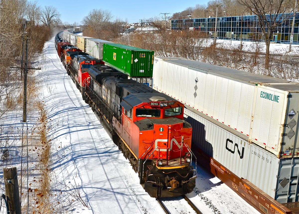 Tanks and racks speeding eastbound. CN 8010, IC 2708 and BNSF 4349 speed by with an oil train (CN 710). At right is CN 120, whose head end had passed just 30 second before. For more train photos, click here.