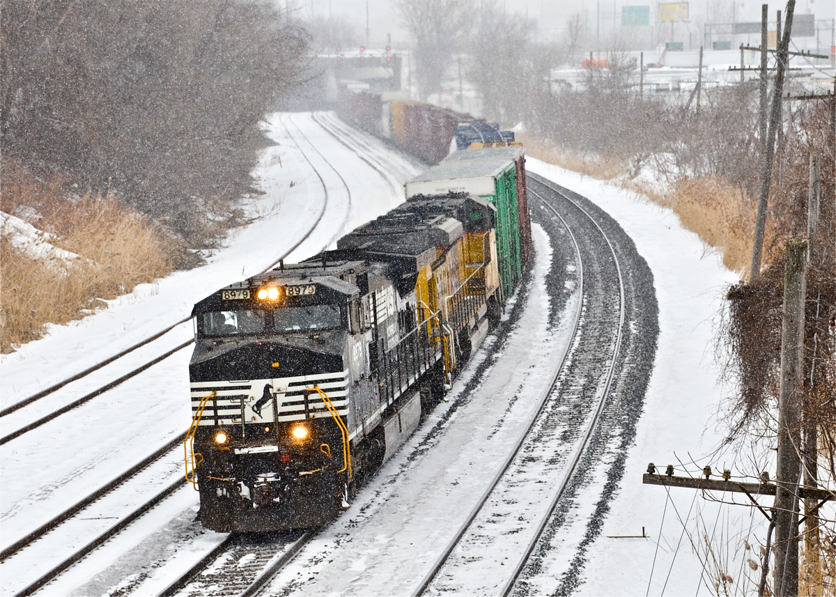 Normally a nocturnal train, CN 529 is passing through Montreal West during the middle of a snowy afternoon with NS 8979 and UP 8583. While power on this train was usually exclusively NS up until recently, there has been an influx of UP power the last couple of months on this train. Until it is interchanged to CN at Rouses Point NY, this train is known as CP 931. For more train photos, click here.