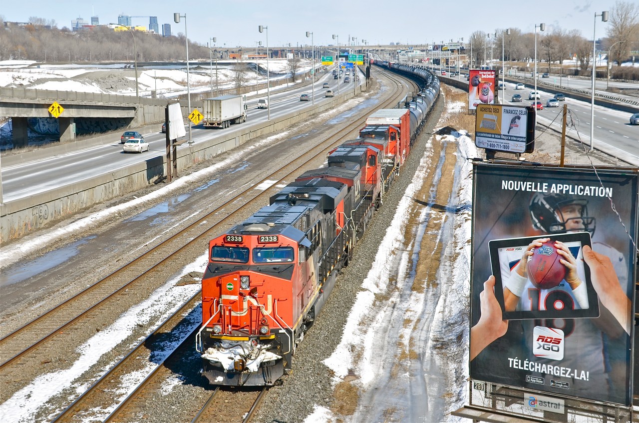 CN 305 heads west towards a crew change at Turcot West, where CN's Montreal sub splits highway 20. Power is CN 2338, CN 2627 and CN 2616 with CN 2223 mid-train. For more train photos, click here.