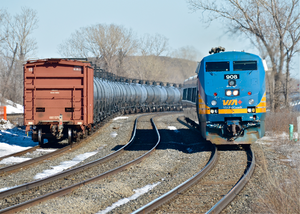 At left is the rear buffer car on CN 720, at right VIA 63 is about to stop at Dorval Station with VIA 908 leading. For more train photos, click here.