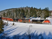 CN 2653, CN 5263 and CN 2322 are eastbound with CN 368 on the scenic Lac St-Jean sub on a beautiful but frigid morning. The train is passing through the scenic s-curve at milepost 37. For more train photos, click <a href=http://www.flickr.com/photos/mtlwestrailfan/>here.</a>