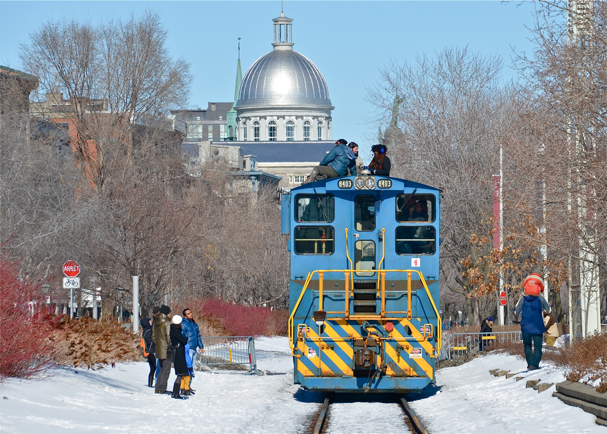 POM 8403 is stopped to participate in the Old Port Symphony, an annual event which involves boats, trains and church bells making a lot of noise. The people on top of the engine are involved in the sound show. It was a nice surprise to see this MP15AC, as most have been replaced by gensets. For more train photos, click here.