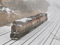 <b>Spring? What spring?!</b> During a snowstorm, BCOL 4620 and CN 5543 were switching CN 149, but their must have been problems with the engines as the power would depart westwards light, to be replaced by two CN Dash9's an hour later. For more train photos, click <a href=http://www.flickr.com/photos/mtlwestrailfan/>here.</a>