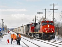 <b><i>3 men, 2 shovels.</i></b> CN 2568 & CN 2154 head east through Dorval with CN 368. The clearing crew seemed to have a supervisor with them! He did nothing the whole platform while the other 2 fellows shovelled. For more train photos, click <a href=http://www.flickr.com/photos/mtlwestrailfan/>here.</a>