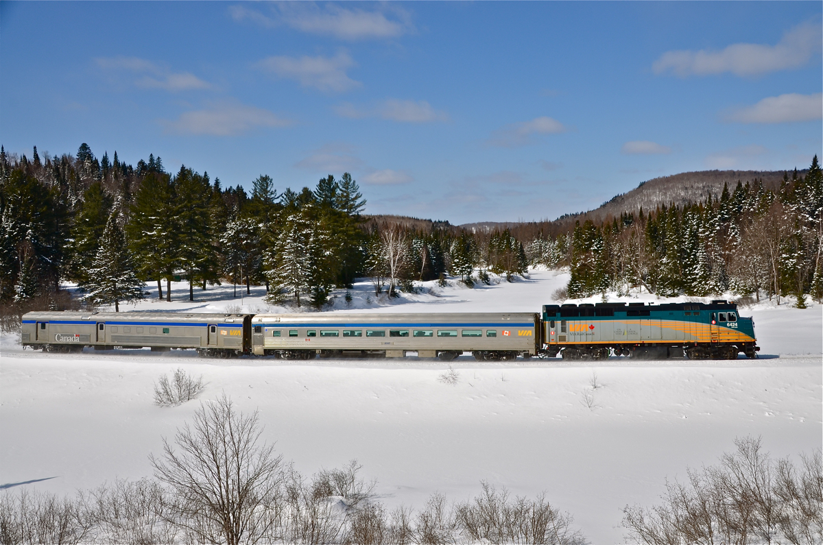 VIA 6424, a coach and a baggage car make up VIA 601 as it heads towards Jonquière on CN's scenic Lac St-Jean sub. For more train photos, click here.