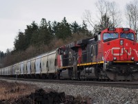 CN Potash train waiting at a red light for CP coal and CN mixed to pass by.