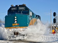 VIA 6405 makes short work of some accumulated snow at a crossing while on its way to Ottawa. For more train photos, click <a href=http://www.flickr.com/photos/mtlwestrailfan/>here.</a>