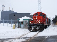 CN L562, the dayshift Port Robinson switcher, is leaving Resolute Paper in Thorold, passing a long-disused gate house.  Usually this trackage is operated by the mill locomotives, but they must be down for the count today.