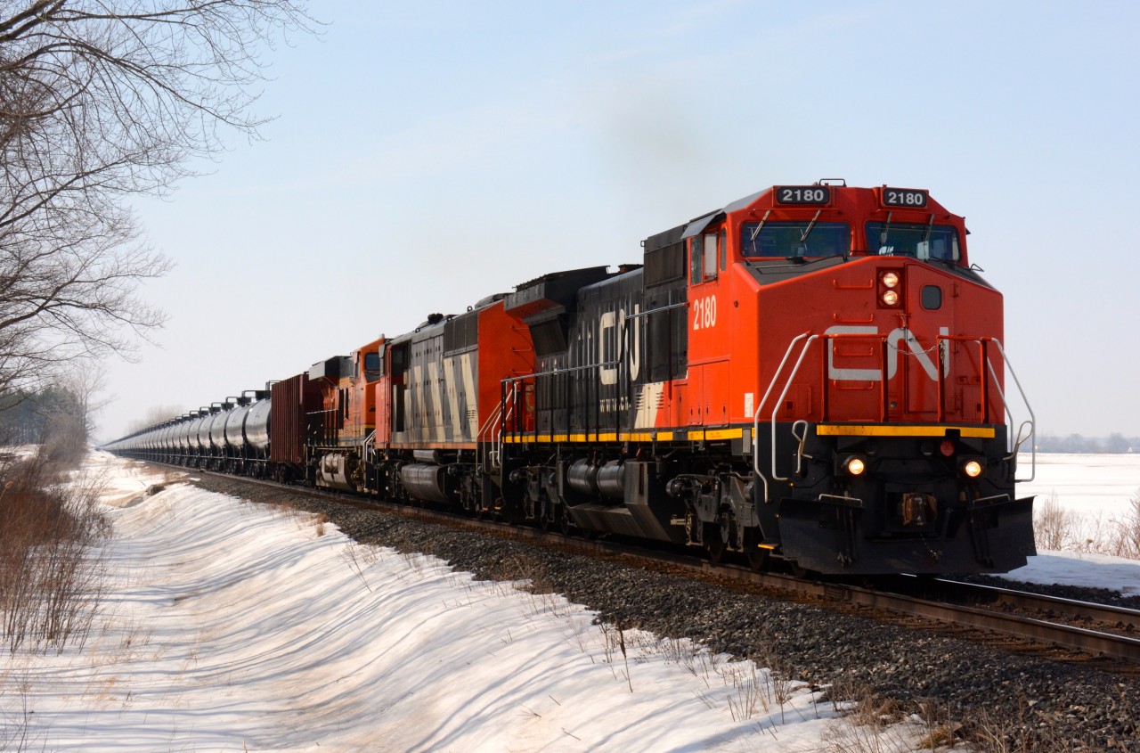 CN2180 with help from CN5515 and BN6590 move slowly past Plowing Match Road with about 100 tankers.