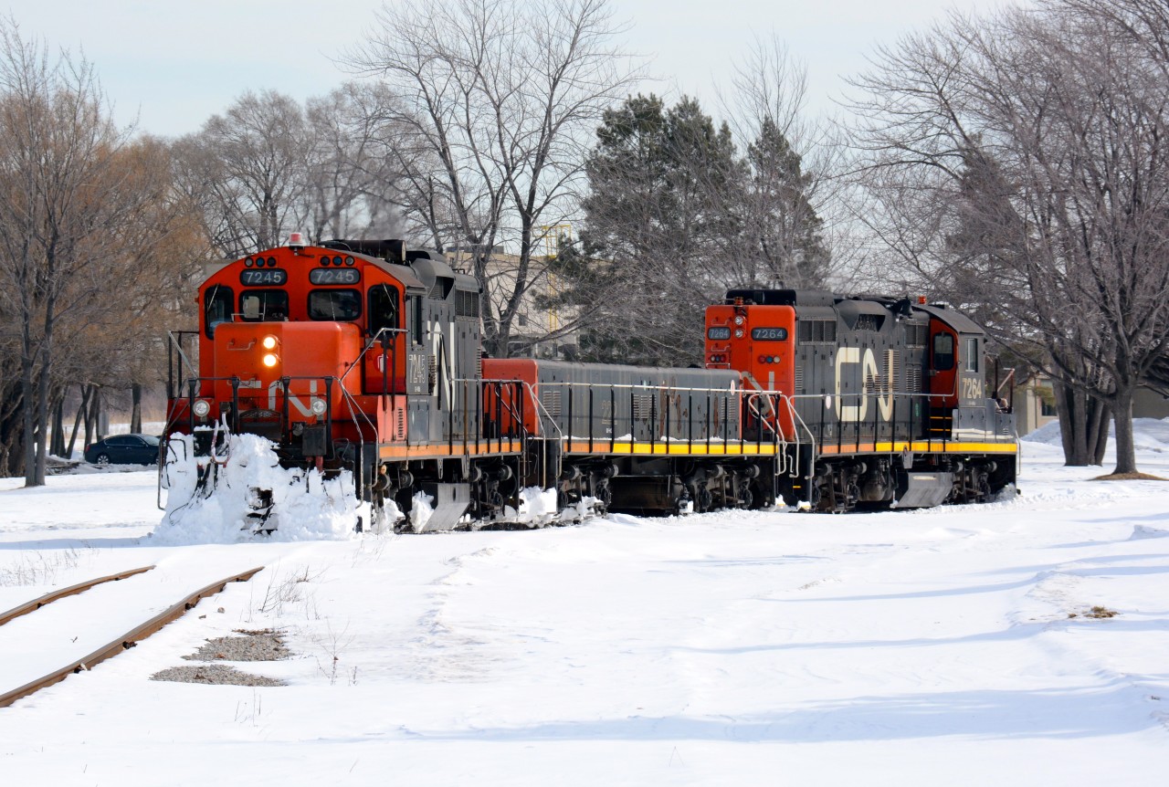 CN7245 with slug 222 and CN7264 plough through the snow on their way to the Cargill elevator in Sarnia.