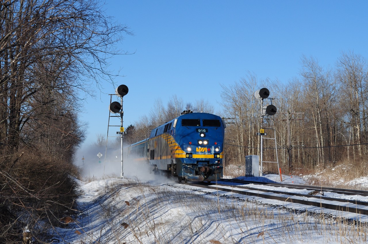 Via Rail GE (2001) P42DH #916 with J train # 52 – 62  splits the mile 319 intermediate signals at track speed.


(at least that GE is other than a  AC4400CW ! )


Track speed limit sign beside the (thirty three year old ) second LRC coach.


Almost shockingly significant March snow in the Carolinian Rouge Hill forest at minus 20C !!


March 13, 2014 image by S. Danko.


Same place, another age:


  same mile 319  


sdfourty.