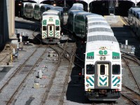 <b>Day and night, always busy</b>. It's only a quarter past four and things are already hopping at Toronto's Union Station: GO 250 trails on Lakeshore East 432's future train, waiting to pull into Track 4 under the train shed to load passengers. GO 213 leads a packed Lakeshore West train 463 out of the station and through the slip switches near John Street interlocking tower. The headlights and markers of at least 3 more trains are visible, loading on Tracks 1, 3 and 5, with another GO pulling into Track 6 on the far right.