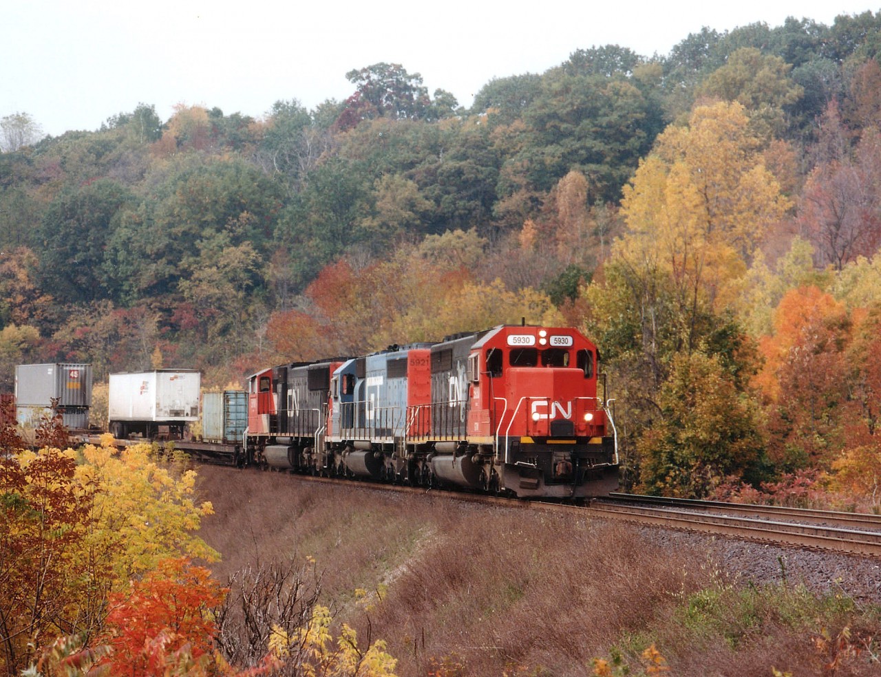 Dundas has always been a beautiful spot for getting fall colour images, as evident with this view of GTW 5930 (CN),GT 5921 and CN 5618 rolling eastward approximately mile 4.5 on the Dundas sub. The leader was former UP 4173, acquired by CN in 1990. the 5921 now retired and the trailing unit, an SD70I, was only a year or so old when this photo was taken.
