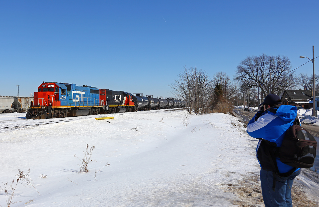 Splash! An unscrupulous motorist has driven deliberately through a large puddle to splash Mark just as he gets a shot of CN 584 leaving the yard to head for the Talbot Spur. The GP38's (GTW 4927-CN 4700) had come in earlier that day on 438 from Windsor and then swapped power with one of the Racecourse-assigned pairs of engines (CN 4791-4774). The next day they would swap back (the GTW engine heading back to Windsor on 439) when CN 4791 developed radio problems. This is the first time in a long time that there has been anything resembling 'foreign' (non-CN) power on the Talbot spur. It was brief, but much appreciated!
