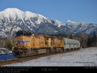 In the glow of afternoon sunlight, CP potash 673 pulled by UP 5521-5514 with mid-train DPU UP5539 and rear DPU CEFX1044 glide past the 65 mile board on CP's Cranbrook Sub under the watchful gaze of the Canadian Rockies. 