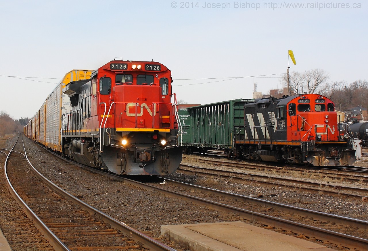 CN 382 cruises through Brantford with CN 2126, they are seen passing CN 580 with CN 4135.