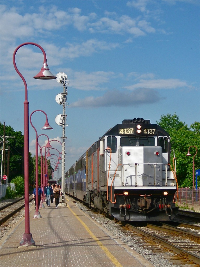 AMT 4137, a GP40FH-2 on lease from New Jersey Transit at the time and since returned, heads west through Montreal West. The triple aspect signal in the background is also no longer in use in Montreal, it was replaced with a newer signal in December 2013. For more train photos, click here.