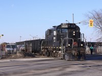 A delightful RS-18u pulls two gondolas of steel pipe from the Energex plant in Welland.