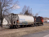 One hopper is being delivered to General Chemicals in Thorold by Trillium.  The switch to the left of the train is the beginning of the old Pine St lead.  The street running tracks are still in place up to Albert St W and I'm sure someone on this site knows when the last train travelled on them.