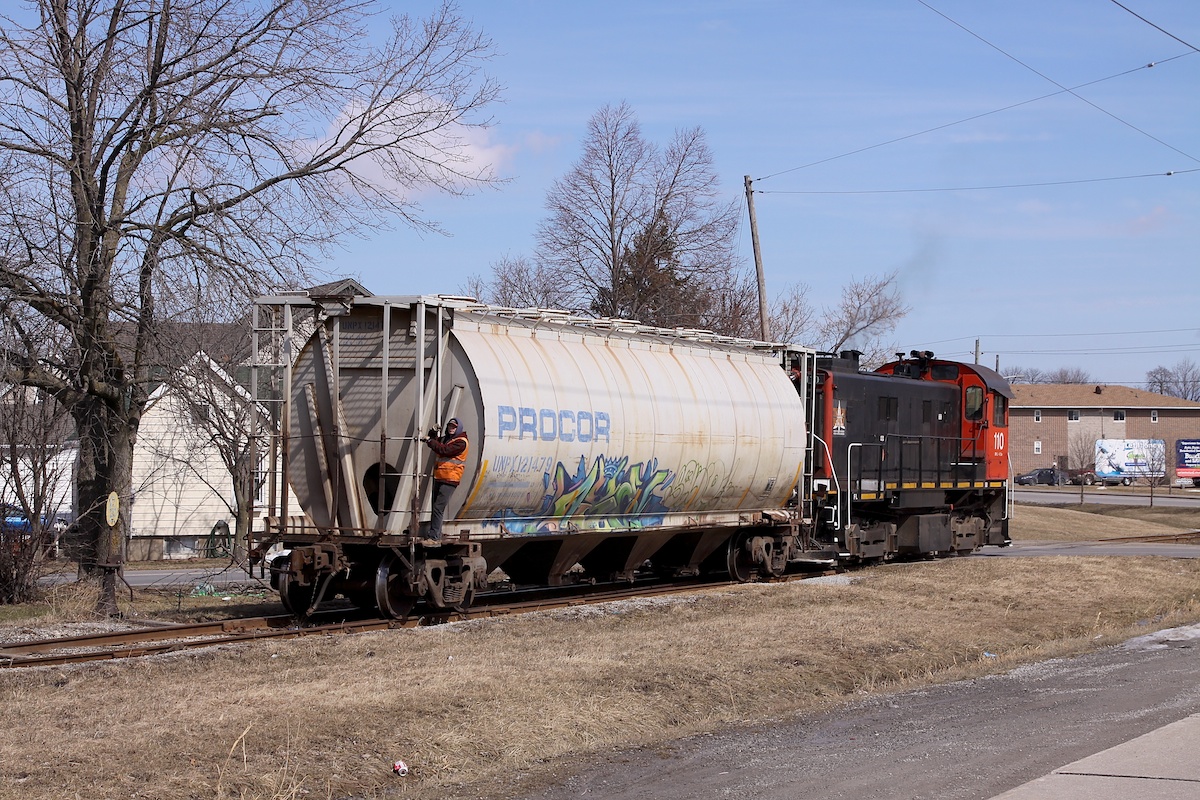 One hopper is being delivered to General Chemicals in Thorold by Trillium.  The switch to the left of the train is the beginning of the old Pine St lead.  The street running tracks are still in place up to Albert St W and I'm sure someone on this site knows when the last train travelled on them.